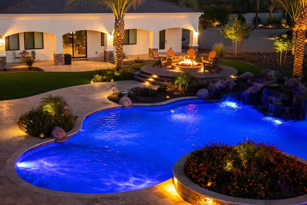 Exquisite Arizona night backyard: a tranquil blue pool and lavish fire pit area glow amidst captivating landscape lighting