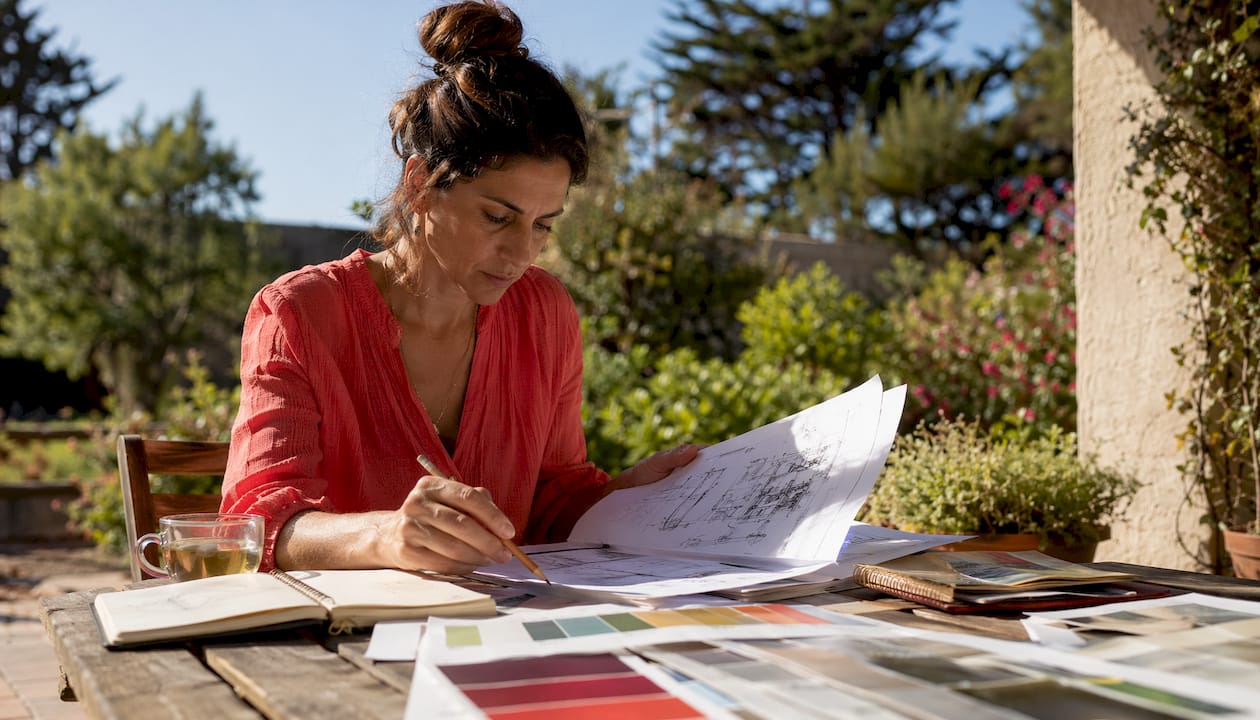 Outdoor lighting designer reviewing blueprints