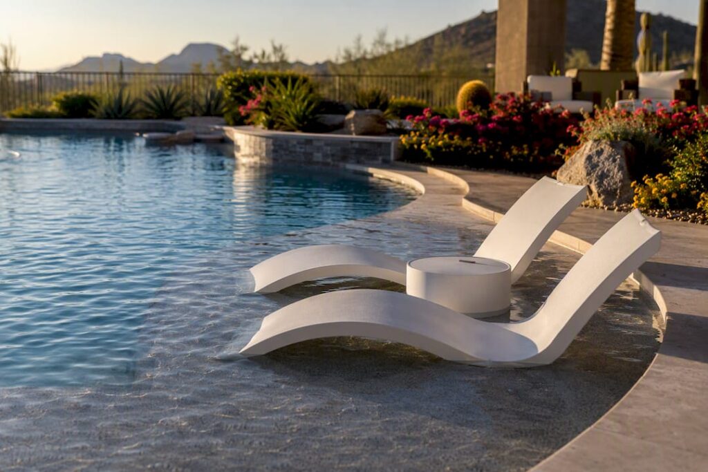 Luxury backyard pool with Baja shelf and loungers