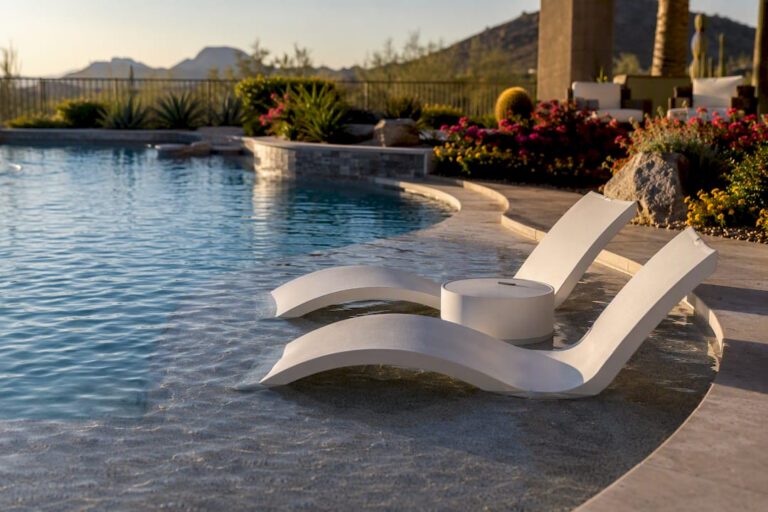 Luxury backyard pool with Baja shelf and loungers