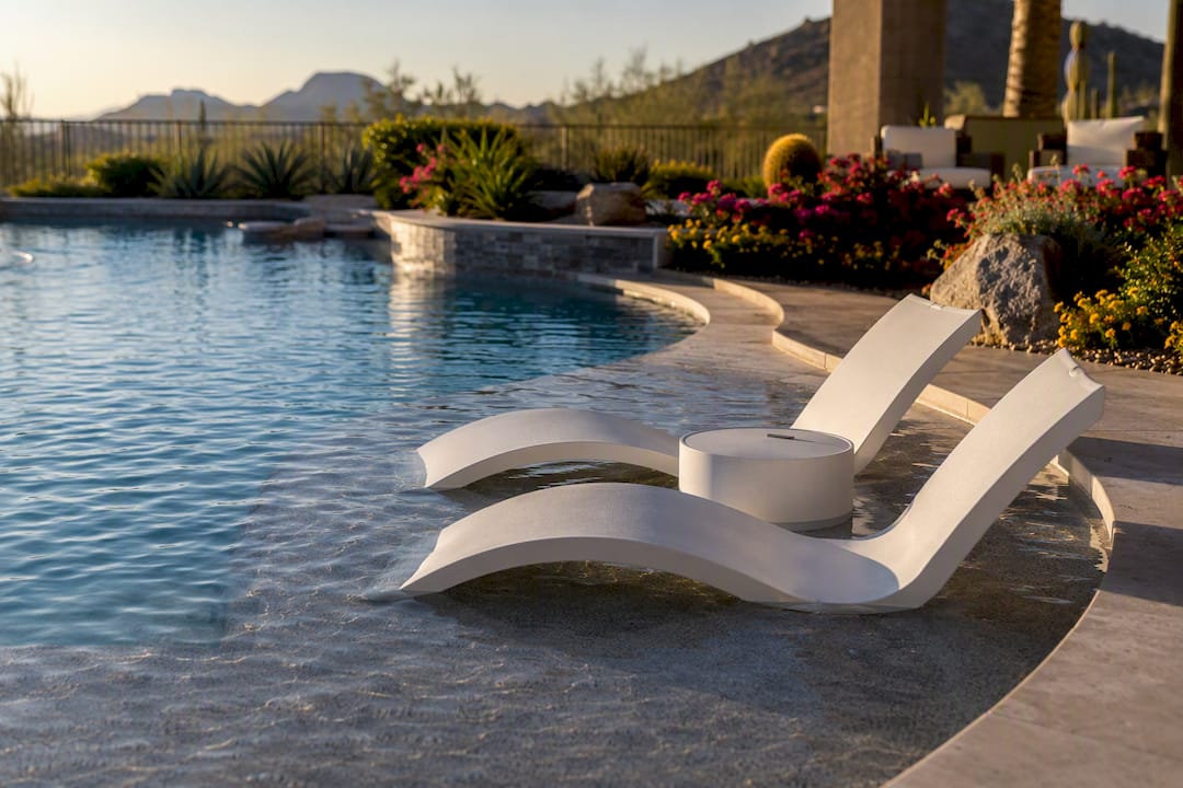 Luxury backyard pool with Baja shelf and loungers